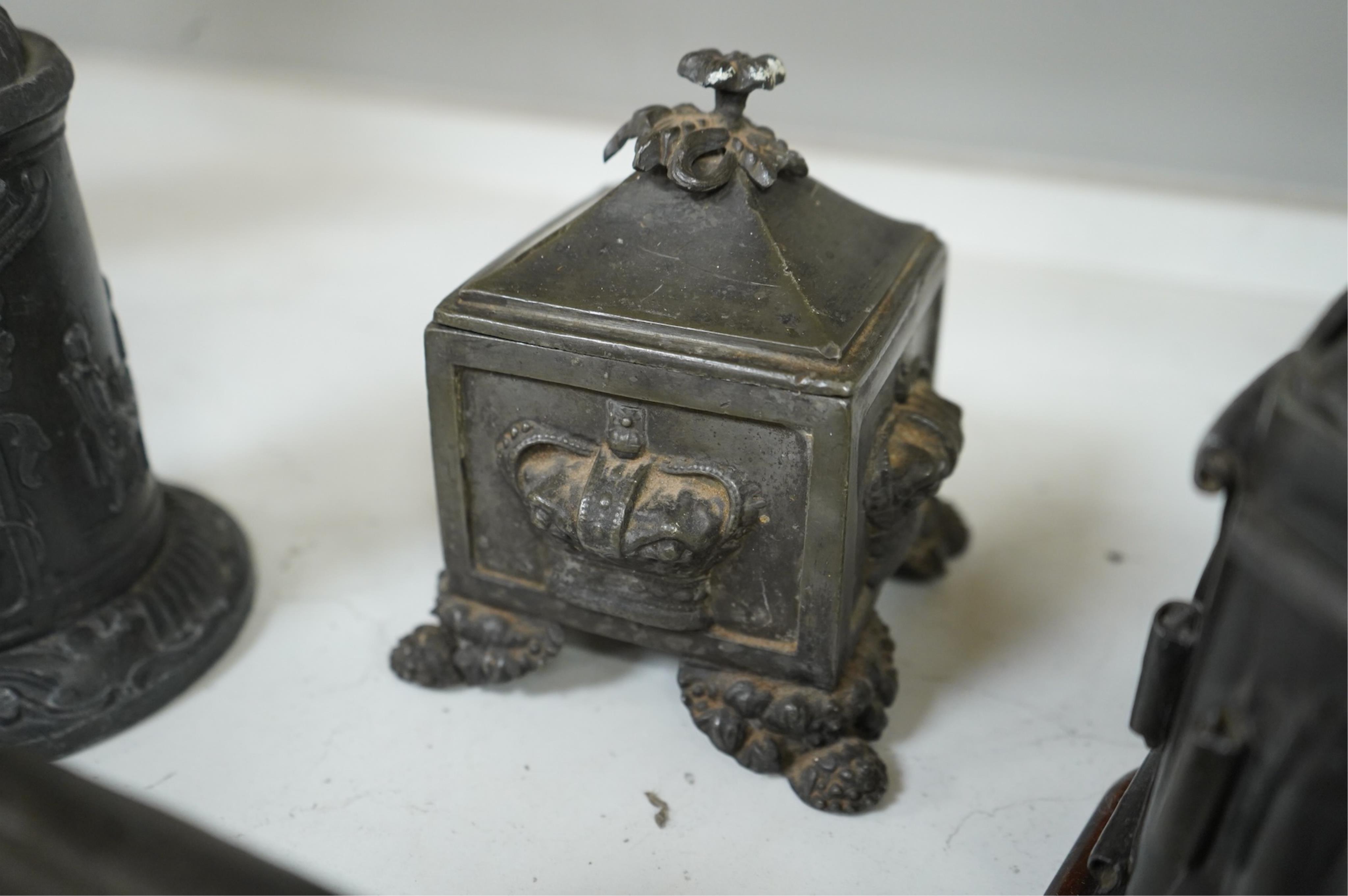 A collection of ten early 19th century lead tobacco boxes to include an octagonal example with remains of paintwork, largest 19cm high